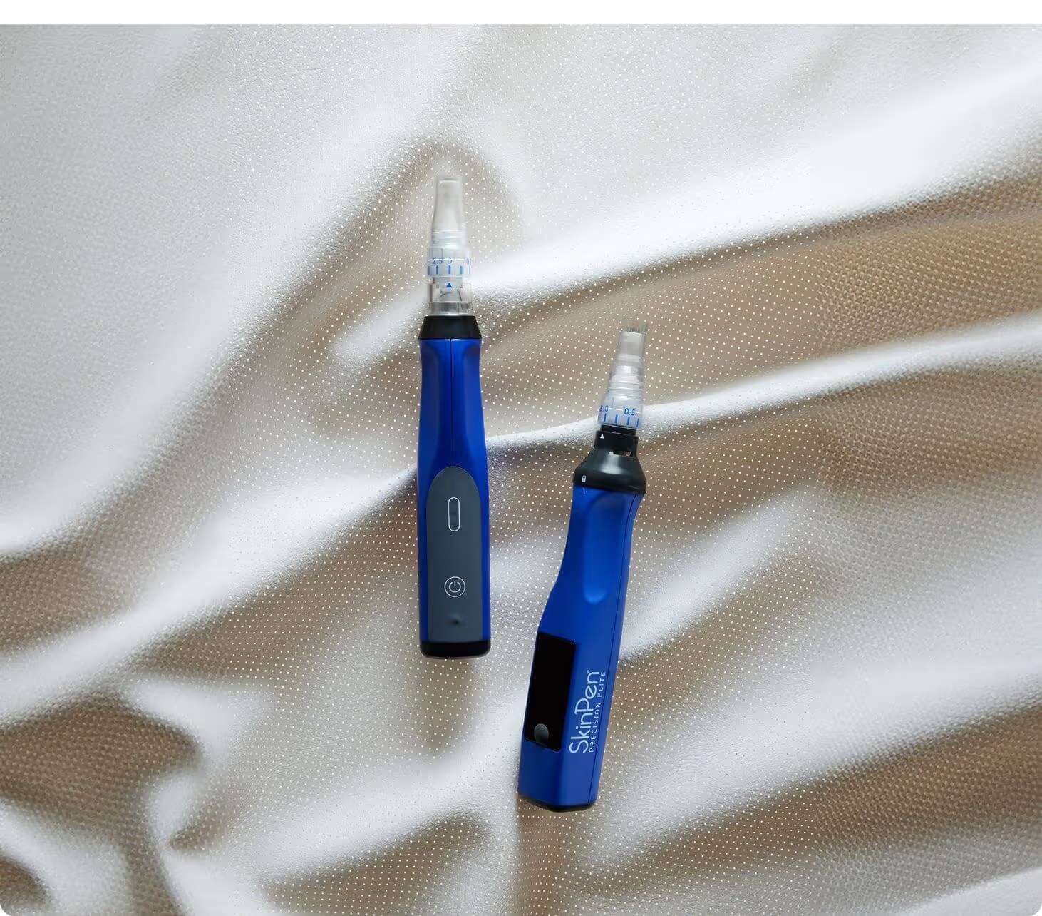 Two SkinPen Precision microneedling devices on satin at The Aesthetic Ranch medical spa in downtown Fort Lauderdale, FL, the medical-grade collagen induction tool used for in-office skin rejuvenation.