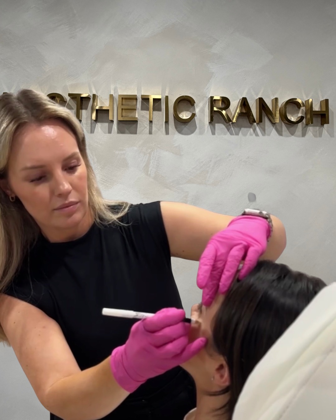 Natasha Wilkes, MSN, APRN, FNP-BC, board-certified Nurse Practitioner at The Aesthetic Ranch in Fort Lauderdale, Florida, marking injection points and prepping a patient for a Radiesse treatment.